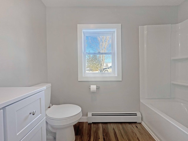 full bathroom with hardwood / wood-style floors, vanity, baseboard heating, toilet, and tub / shower combination