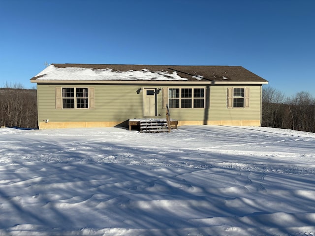 view of snow covered back of property