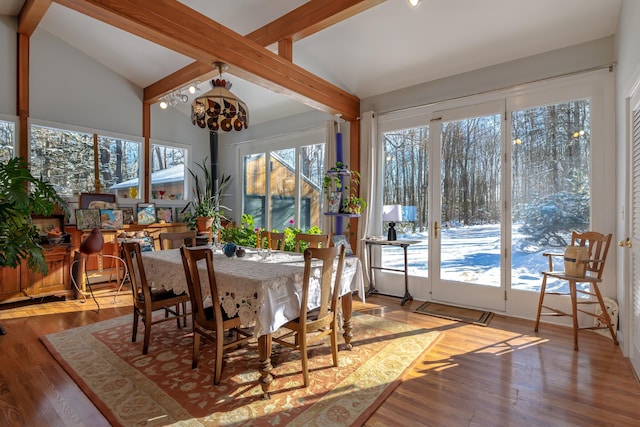 sunroom / solarium featuring lofted ceiling with beams