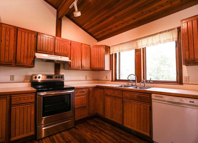 kitchen featuring dishwasher, stainless steel electric range oven, under cabinet range hood, a sink, and lofted ceiling