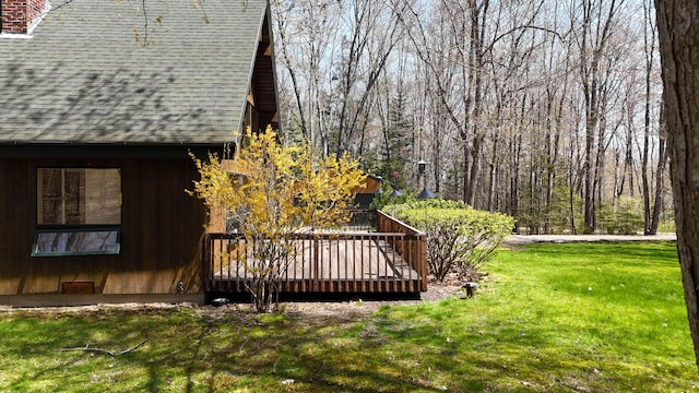 view of green lawn featuring a deck