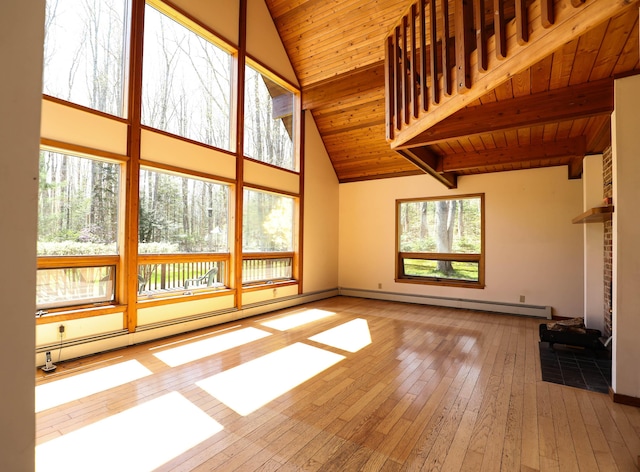unfurnished living room with a baseboard radiator, hardwood / wood-style floors, high vaulted ceiling, beam ceiling, and baseboards