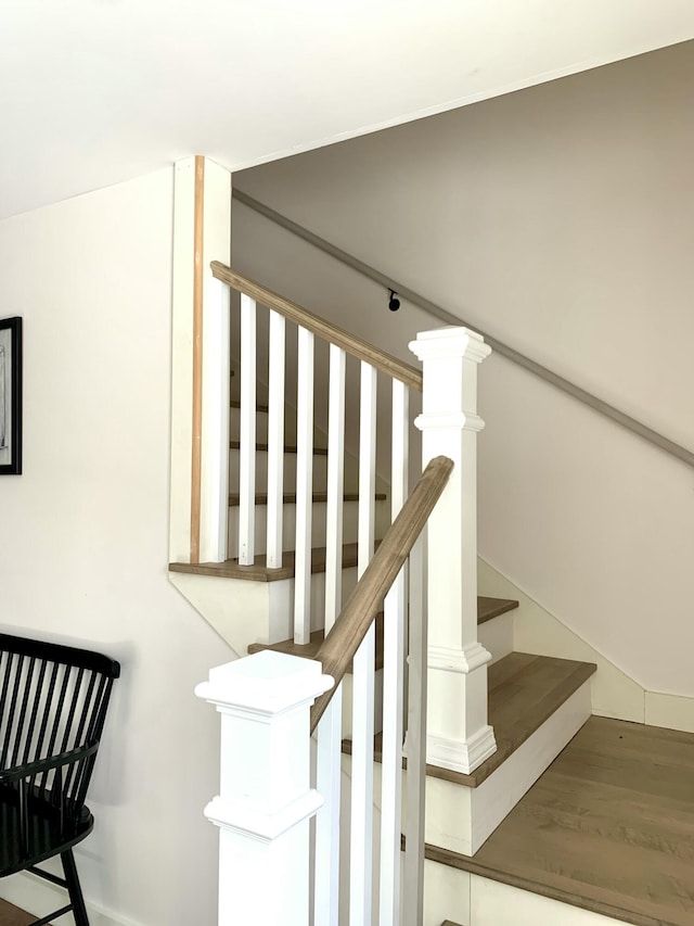 stairway featuring wood-type flooring