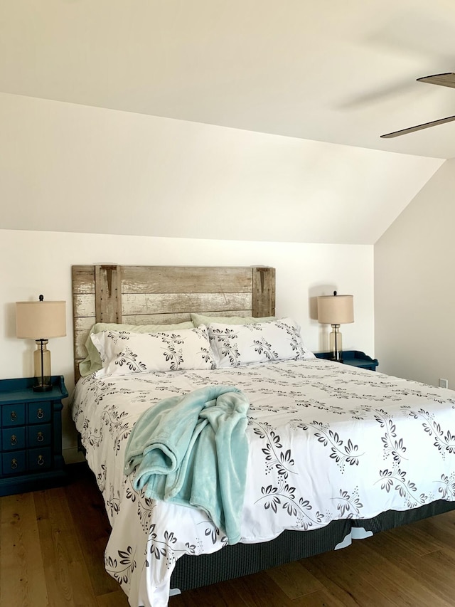 bedroom featuring dark wood-type flooring, ceiling fan, and vaulted ceiling