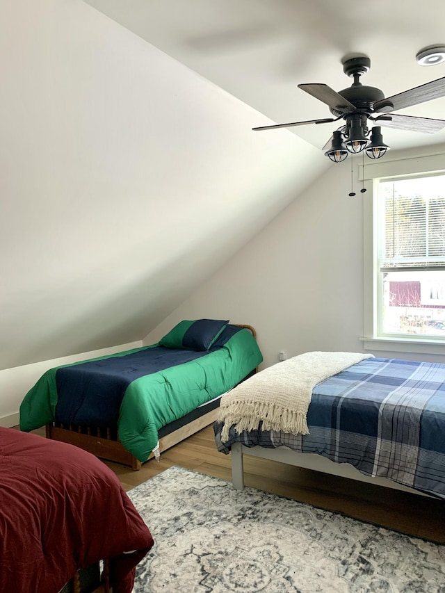 bedroom featuring lofted ceiling, wood-type flooring, and ceiling fan