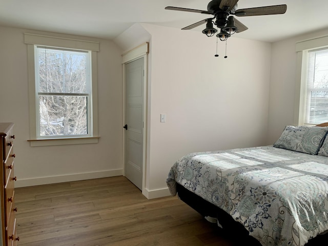 bedroom with ceiling fan and light hardwood / wood-style floors