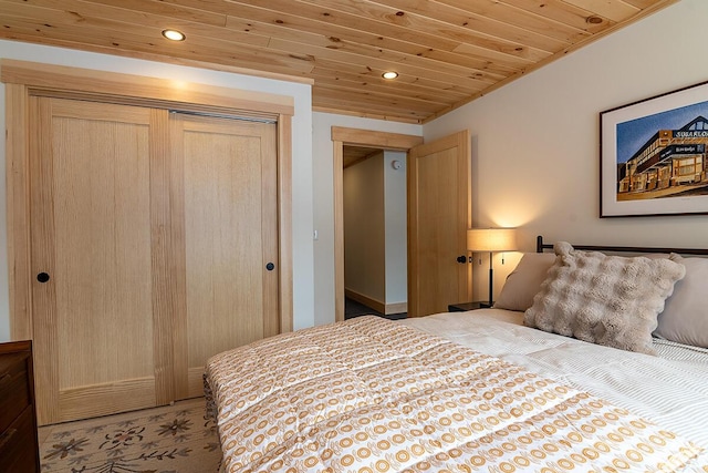 bedroom featuring wood ceiling and a closet