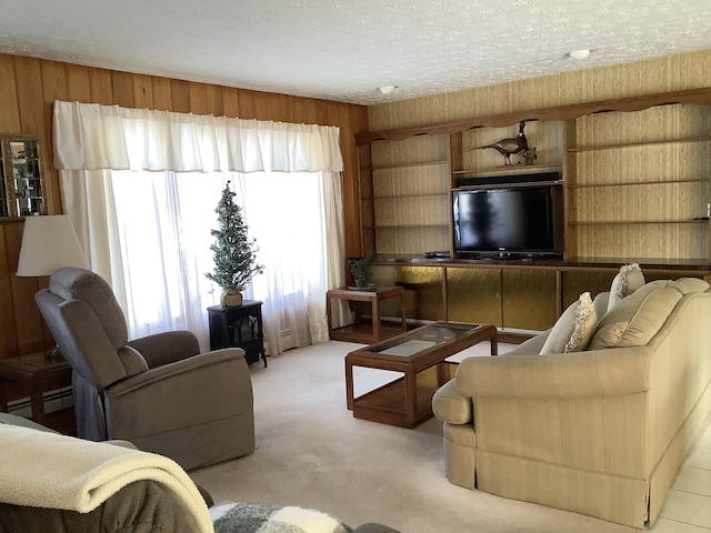 living room featuring baseboard heating, light colored carpet, a textured ceiling, and wood walls