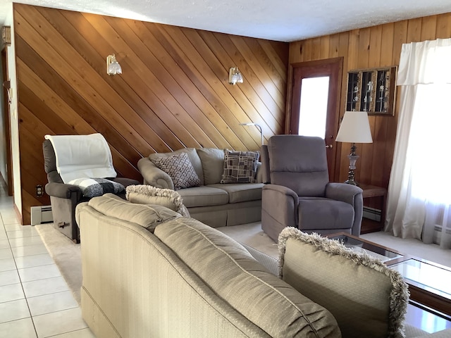 living room featuring light tile patterned floors, wooden walls, and a baseboard radiator