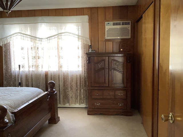 carpeted bedroom featuring an AC wall unit and wood walls