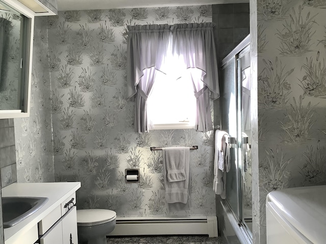 bathroom with vanity, a baseboard heating unit, toilet, and an enclosed shower