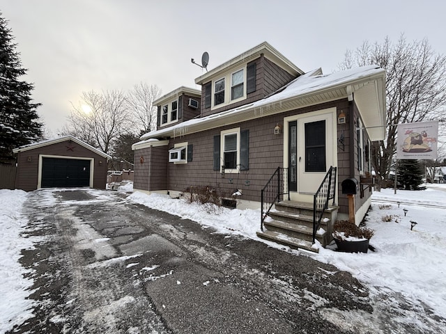 view of front of home with a garage and an outdoor structure