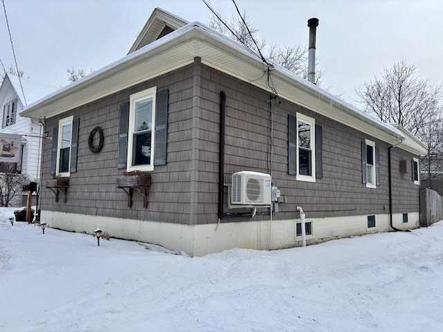 view of snowy exterior featuring ac unit