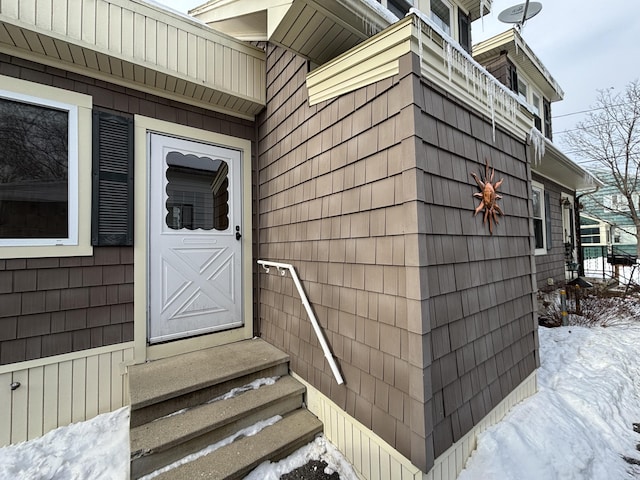 view of snow covered property entrance