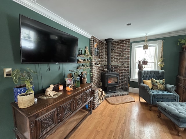 living room with hardwood / wood-style floors, crown molding, and a wood stove