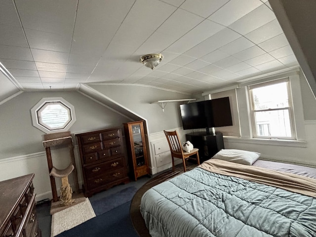 bedroom with ornamental molding and lofted ceiling