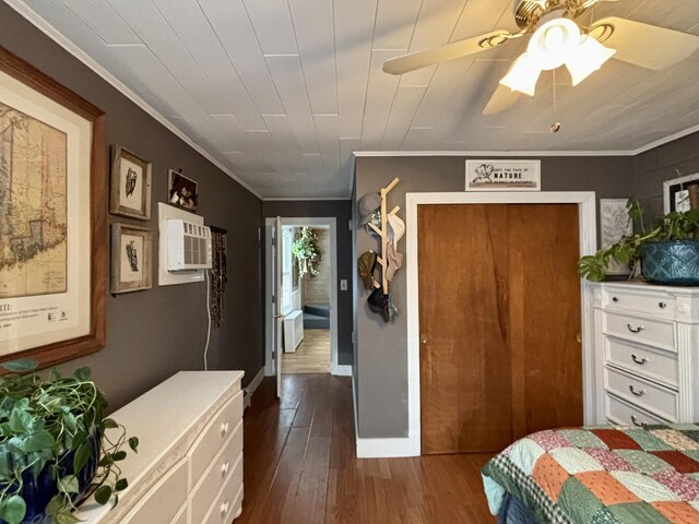 bedroom featuring ornamental molding, an AC wall unit, dark hardwood / wood-style floors, and ceiling fan