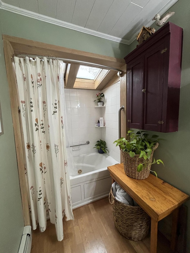 bathroom featuring a skylight, hardwood / wood-style floors, shower / bath combo with shower curtain, and a baseboard heating unit