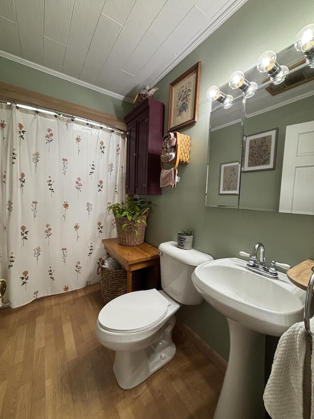 bathroom with ornamental molding, hardwood / wood-style floors, walk in shower, and toilet