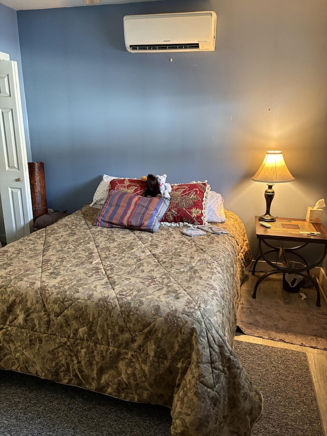 bedroom featuring a wall unit AC