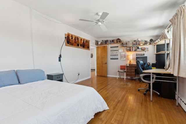 bedroom with wood-type flooring, ceiling fan, and a baseboard radiator