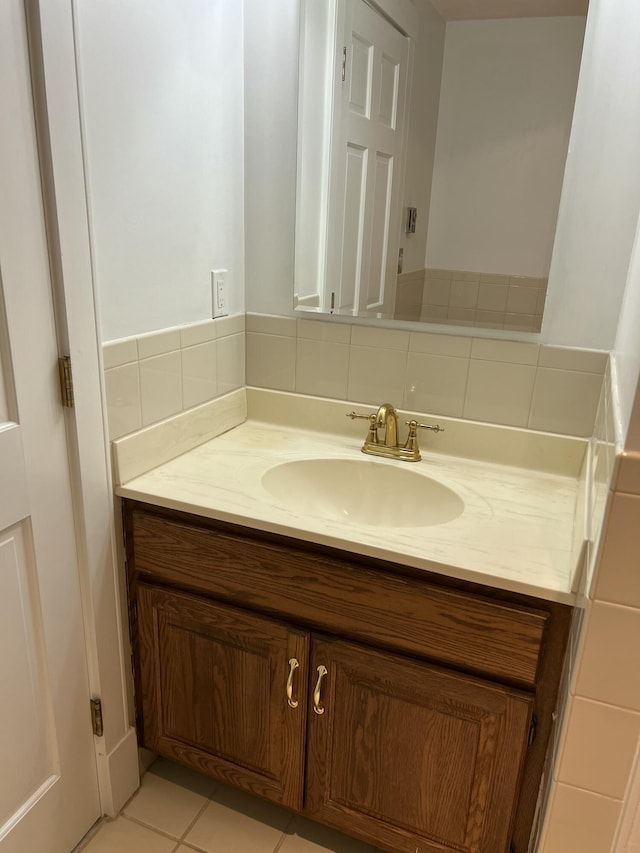 bathroom featuring tile patterned floors, vanity, and backsplash