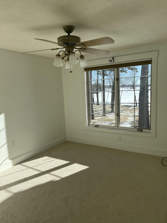 carpeted spare room featuring ceiling fan