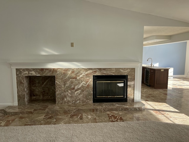 details featuring a premium fireplace, sink, and beverage cooler