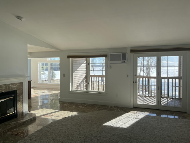 unfurnished living room featuring a wall mounted air conditioner, a fireplace, and vaulted ceiling