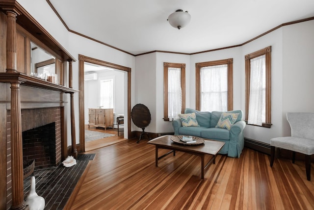 living room featuring ornamental molding, a brick fireplace, and hardwood / wood-style floors