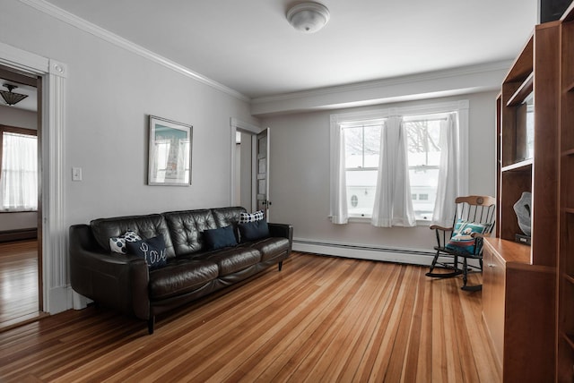 living room with a baseboard radiator, wood-type flooring, and ornamental molding