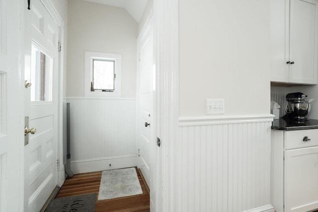 entryway featuring dark wood-type flooring and vaulted ceiling