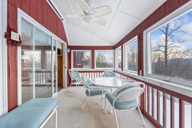 sunroom featuring ceiling fan, a healthy amount of sunlight, and vaulted ceiling