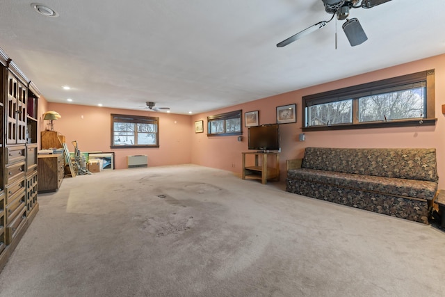 living room featuring ceiling fan and carpet