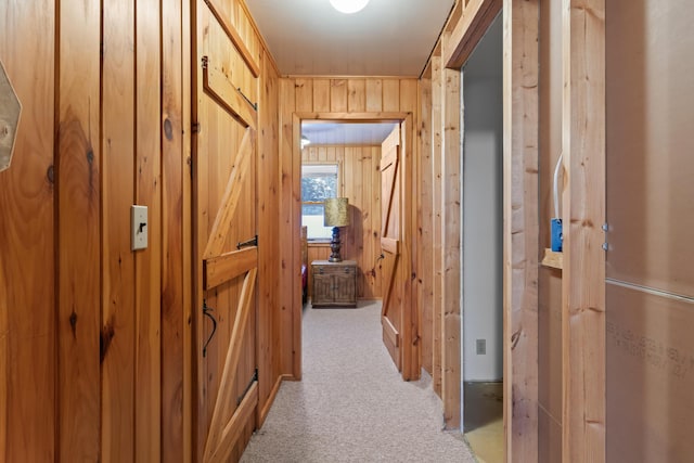 corridor with light carpet and wooden walls