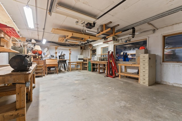 garage featuring a garage door opener and a workshop area