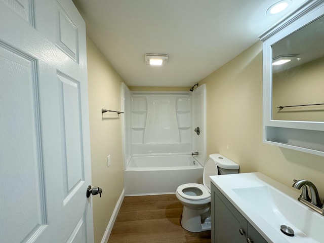 full bathroom with hardwood / wood-style flooring, vanity, shower / tub combination, and toilet