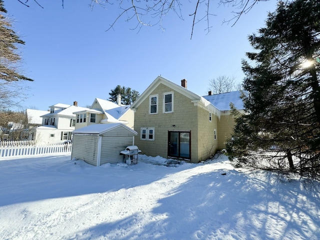 view of snow covered rear of property