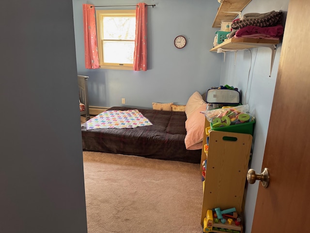 carpeted bedroom with baseboard heating