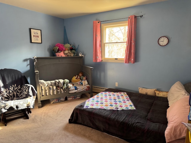 bedroom with a baseboard heating unit and carpet floors