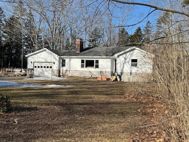 view of front of home featuring a garage, a front yard, and a chimney