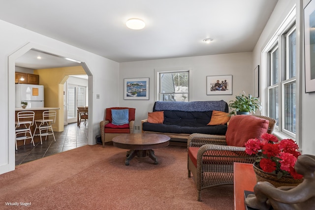 16 Hanna Ln, Bristol, ME 04539 - living room with arched walkways, tile patterned floors, and carpet