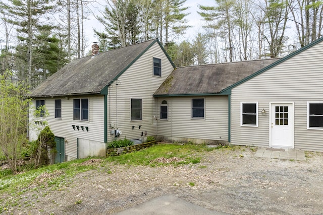 16 Hanna Ln, Bristol, ME 04539 - back of property with a shingled roof and a chimney