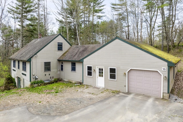 16 Hanna Ln, Bristol, ME 04539 - view of front facade with a garage, a shingled roof, asphalt driveway, and view of wooded area