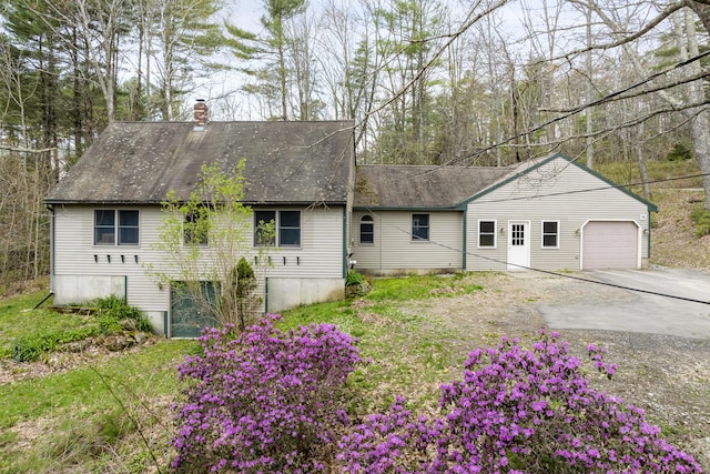 16 Hanna Ln, Bristol, ME 04539 - view of front of house featuring a garage, a chimney, concrete driveway, and a shingled roof