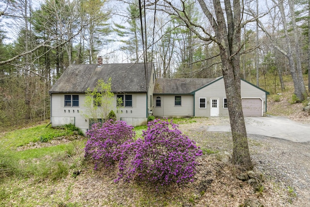 16 Hanna Ln, Bristol, ME 04539 - view of front facade featuring a chimney, driveway, roof with shingles, and an attached garage