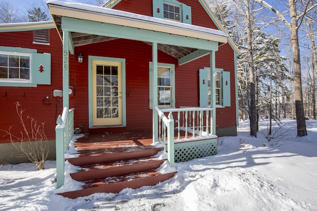 view of snow covered property entrance