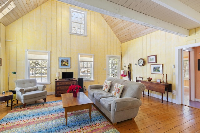 living room featuring hardwood / wood-style floors, wood ceiling, plenty of natural light, and beamed ceiling