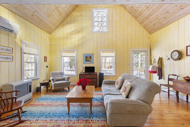 living room with heating unit, wood ceiling, high vaulted ceiling, an AC wall unit, and light wood-type flooring