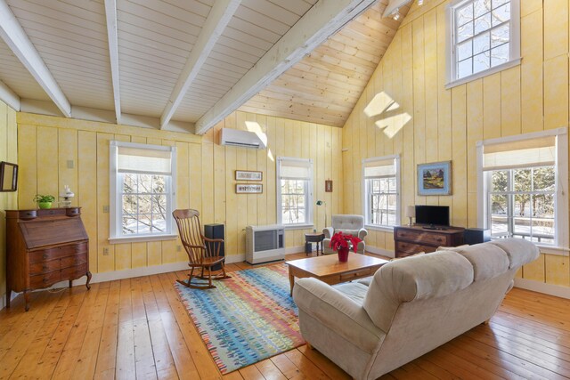 living room with heating unit, high vaulted ceiling, an AC wall unit, beamed ceiling, and light hardwood / wood-style floors